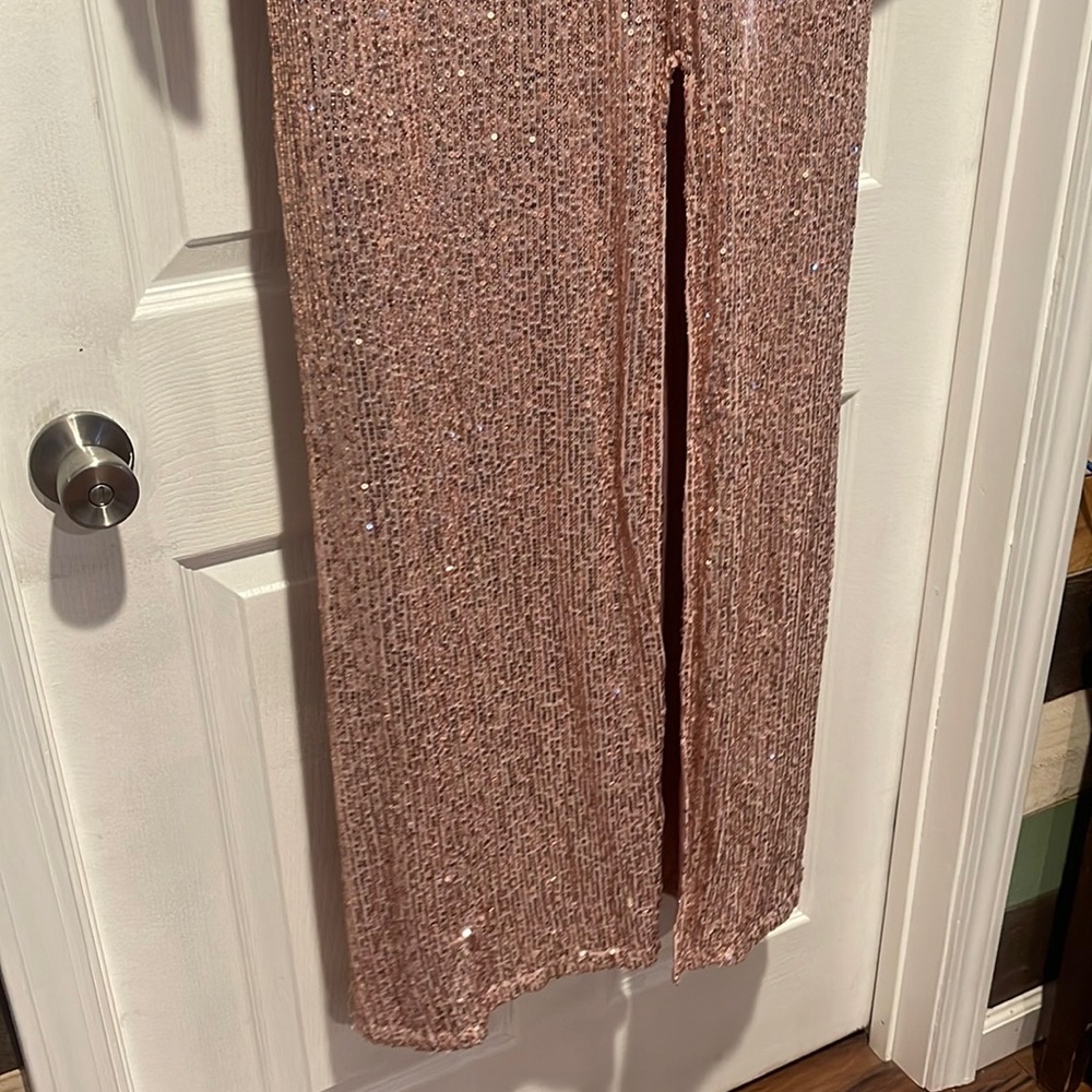 Blush colored floor light longsleeve dress with slit.